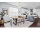 Elegant dining room features a stylish chandelier, a modern table, and abundant natural light at 630 Dorman St, Indianapolis, IN 46202