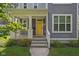 Home's bright yellow front door with white trim and a welcoming front porch at 630 Dorman St, Indianapolis, IN 46202