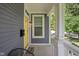 Inviting front porch featuring a yellow door, black mailbox, and stylish decor at 630 Dorman St, Indianapolis, IN 46202