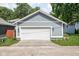 Exterior shot of a detached, light-blue garage with a white garage door and side entry at 630 Dorman St, Indianapolis, IN 46202
