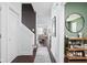 Hallway with dark wood floors, white trim, and stylish decor leading to the living room at 630 Dorman St, Indianapolis, IN 46202