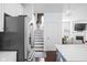 View of kitchen opening up into hall with stairway and the cozy living room beyond at 630 Dorman St, Indianapolis, IN 46202