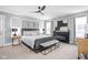 A beautifully staged main bedroom boasts a fireplace, neutral tones, and a modern ceiling fan at 630 Dorman St, Indianapolis, IN 46202