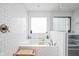 Enjoy a relaxing soak in this modern bathtub featuring subway tile and serene natural light at 630 Dorman St, Indianapolis, IN 46202