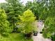 Aerial shot of a home featuring mature shade trees, manicured lawn, and a paved driveway at 6379 Monitor Dr, Indianapolis, IN 46220