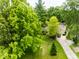 Aerial of home surrounded by shade trees, manicured lawn, and a paved driveway at 6379 Monitor Dr, Indianapolis, IN 46220