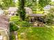An aerial showcases the home's backyard with a gazebo, lush garden, stone patio, and outdoor seating at 6379 Monitor Dr, Indianapolis, IN 46220