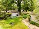 Well maintained landscaped yard featuring various outbuildings, shade trees and walkways at 6379 Monitor Dr, Indianapolis, IN 46220
