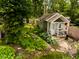 Charming backyard featuring a quaint shed with a porch and lush landscaping at 6379 Monitor Dr, Indianapolis, IN 46220