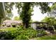 Serene backyard with a charming pergola, lush greenery, and a view of the house at 6379 Monitor Dr, Indianapolis, IN 46220