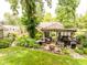Backyard with a charming gazebo, complete with outdoor furniture, grill, and lush landscaping at 6379 Monitor Dr, Indianapolis, IN 46220