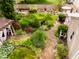 Aerial view of the meticulously landscaped backyard, with a garden, gazebo, patio, and lush greenery at 6379 Monitor Dr, Indianapolis, IN 46220