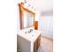 Bright bathroom with wooden vanity, framed mirror, and a shower with a decorative curtain at 6379 Monitor Dr, Indianapolis, IN 46220