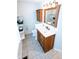 Updated bathroom with wooden vanity, quartz countertop, framed mirror, and built-in shelving at 6379 Monitor Dr, Indianapolis, IN 46220