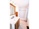 Bright bathroom featuring a wooden vanity, framed mirror, and a tiled shower with curtain at 6379 Monitor Dr, Indianapolis, IN 46220