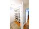 Spacious walk-in closet with built-in shelves and ample storage space with hardwood floors and decorated overhead at 6379 Monitor Dr, Indianapolis, IN 46220