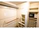 Well-organized walk-in closet with multiple shelves, hanging rods, and a secure safe at 6379 Monitor Dr, Indianapolis, IN 46220