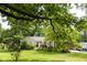 Home with a well-manicured front yard, featuring a variety of plants and green grass at 6379 Monitor Dr, Indianapolis, IN 46220