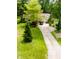 Aerial view of home with a long driveway, spacious front yard, and lush greenery at 6379 Monitor Dr, Indianapolis, IN 46220