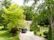 Aerial view of a charming home with a long driveway, mature trees, and well-kept lawn at 6379 Monitor Dr, Indianapolis, IN 46220