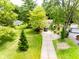 Aerial view of home with a long driveway, spacious front yard, and lush greenery at 6379 Monitor Dr, Indianapolis, IN 46220