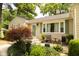 Inviting home entrance with a green door, shuttered windows and an ornamental tree at 6379 Monitor Dr, Indianapolis, IN 46220