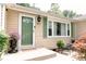 Home's entry featuring an ornate green front door, green shutters and flower filled planters at 6379 Monitor Dr, Indianapolis, IN 46220