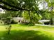 Charming home with well-manicured lawn, mature trees, and tidy landscaping at 6379 Monitor Dr, Indianapolis, IN 46220