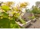 Backyard garden featuring raised garden beds with flowers, lush greenery, privacy fence, and outdoor solar lighting at 6379 Monitor Dr, Indianapolis, IN 46220