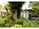 Beautiful garden featuring a unique sculpture, lush plants, and a charming pergola at 6379 Monitor Dr, Indianapolis, IN 46220