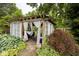 An inviting backyard gazebo with a stone path, drapes, and lush foliage at 6379 Monitor Dr, Indianapolis, IN 46220