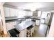 Updated kitchen with stainless steel appliances, center island, and ample countertop space at 6379 Monitor Dr, Indianapolis, IN 46220