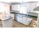 Kitchen with stainless steel appliances, ample counter space, and a view into the dining area at 6379 Monitor Dr, Indianapolis, IN 46220