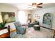 Inviting living room with a ceiling fan, gray sofa, patterned chair, area rug, and natural light at 6379 Monitor Dr, Indianapolis, IN 46220