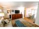 Cozy living room with a tan sofa, wood floors, an area rug and a dining area at 6379 Monitor Dr, Indianapolis, IN 46220
