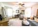 Cozy living room with a ceiling fan, sofa, area rug, desk, and natural light from the windows at 6379 Monitor Dr, Indianapolis, IN 46220