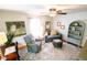 Inviting living room with a ceiling fan, gray sofa, patterned chair, area rug, and natural light at 6379 Monitor Dr, Indianapolis, IN 46220