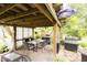Inviting outdoor dining space featuring stone flooring, a pergola, and a built-in grill area at 6379 Monitor Dr, Indianapolis, IN 46220