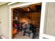 View into a shed filled with shelving, tools, lawn mower and yard maintenance equipment at 6379 Monitor Dr, Indianapolis, IN 46220