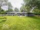 Large fenced backyard offers plenty of space for outdoor entertaining and recreation at 6546 Derbyshire Rd, Indianapolis, IN 46227