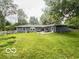 Spacious backyard offering lush lawn, mature trees, and serene outdoor space at 6546 Derbyshire Rd, Indianapolis, IN 46227