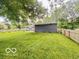 Spacious backyard featuring a well-manicured lawn and partial fencing at 6546 Derbyshire Rd, Indianapolis, IN 46227