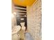 Bathroom with a toilet, sink, shower with a patterned curtain, and built-in shelves at 6546 Derbyshire Rd, Indianapolis, IN 46227