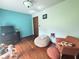 Bedroom with hardwood floors, a dresser with a television, and a seating area at 6546 Derbyshire Rd, Indianapolis, IN 46227