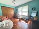 Bedroom with hardwood floors, large closet, window, dresser, and sitting area at 6546 Derbyshire Rd, Indianapolis, IN 46227