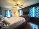 Spacious bedroom features a large bed, dark walls, and lots of natural light at 6546 Derbyshire Rd, Indianapolis, IN 46227