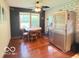 Dining area featuring hardwood floors, bright windows, and stainless steel refrigerator at 6546 Derbyshire Rd, Indianapolis, IN 46227