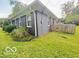 Side view of a house with a well-maintained yard and landscaping at 6546 Derbyshire Rd, Indianapolis, IN 46227