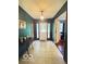 Inviting home foyer featuring tile flooring, elegant lighting, and a view into an adjacent office area at 6546 Derbyshire Rd, Indianapolis, IN 46227