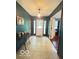 Front foyer with tile flooring, a chandelier, and a glimpse into an adjacent room at 6546 Derbyshire Rd, Indianapolis, IN 46227